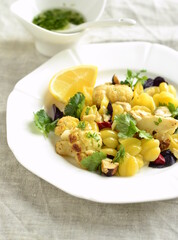 Corn pasta with cauliflower, hazelnuts and herbs, vertical,  copy space