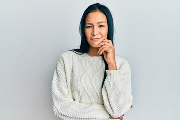 Beautiful hispanic woman wearing casual winter sweater over white background thinking concentrated...