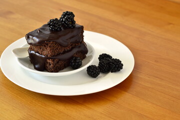 Chocolate zucchini cake with chocolate ganash and fresh blackberries,  copy space