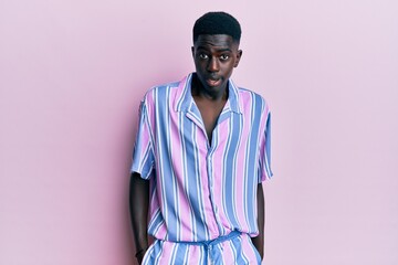Young african american man wearing casual clothes clueless and confused expression. doubt concept.