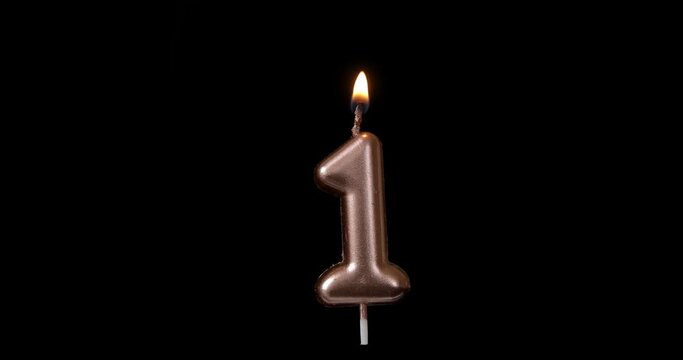 Realistic full-sized single birthday candlelight one 1 first number isolated on black background. Fire is floating. Footage ready for compositing, copy paste into your project. 4k, apple prores 422