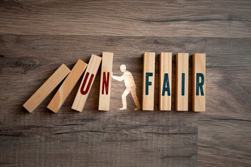 Pieces of wood with message fair and unfair on wooden background - obrazy, fototapety, plakaty