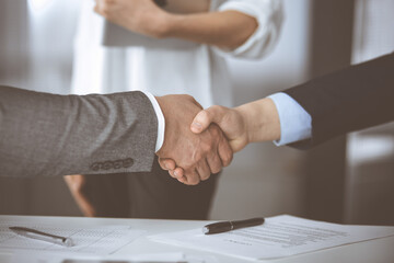 Business people shaking hands finishing contract signing, close-up. Business communication concept. Handshake and marketing