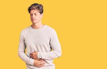 Young handsome man wearing casual clothes with hand on stomach because indigestion, painful illness...