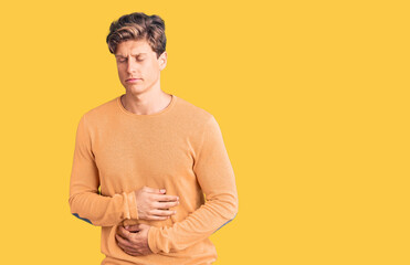 Young handsome man wearing casual clothes with hand on stomach because indigestion, painful illness...
