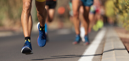 Marathon running race, people feet on city road