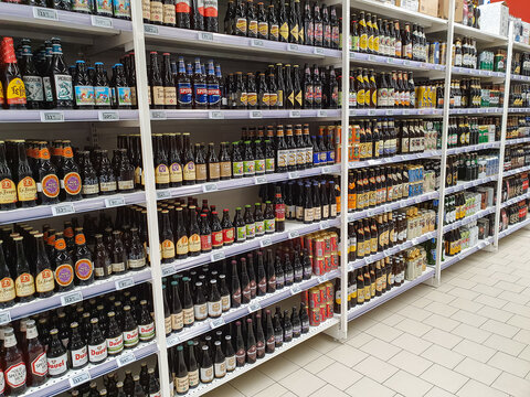 Bucharest, Romania - November 06, 2020 – Variety of crafted beers for sale in a shop, branded bottles on a shelf display in supermarket, with copy space
