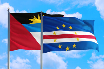 Cape Verde and Antigua and Barbuda national flag waving in the windy deep blue sky. Diplomacy and international relations concept.