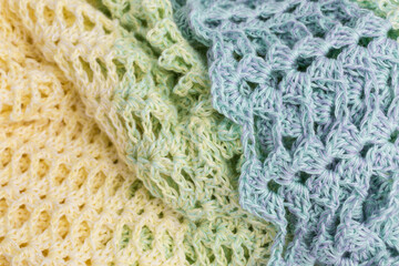 handmade multicolor crochet background in yellow, green and blue with double crochet stitches