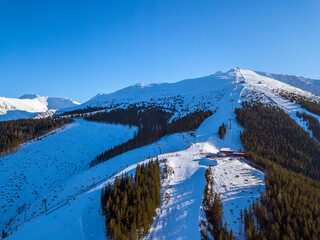 Sun and Winter Slopes at the Ski Resort. Aerial View