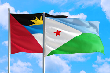 Djibouti and Antigua and Barbuda national flag waving in the windy deep blue sky. Diplomacy and international relations concept.