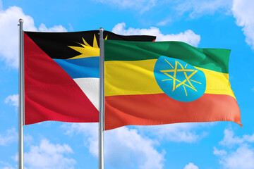 Ethiopia and Antigua and Barbuda national flag waving in the windy deep blue sky. Diplomacy and international relations concept.