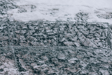 Reinforcing mesh on stones. Strengthening along the road
