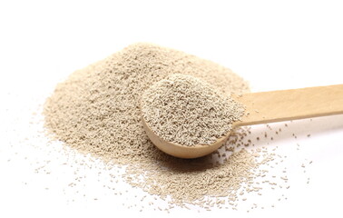 Dry yeast in wooden spoon isolated on white background 