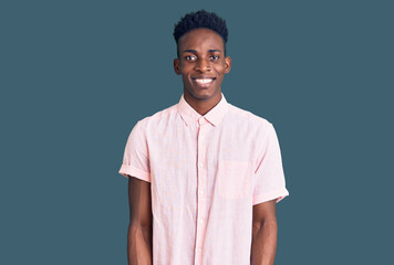 Young african american man wearing casual clothes with a happy and cool smile on face. lucky person.