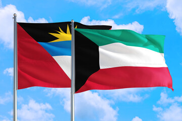 Kuwait and Antigua and Barbuda national flag waving in the windy deep blue sky. Diplomacy and international relations concept.