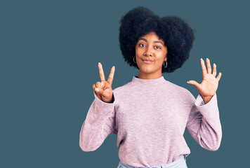Young african american girl wearing casual clothes showing and pointing up with fingers number seven while smiling confident and happy.