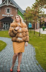 Gorgeous plus size blonde European woman in luxury fur coat, women's beauty. Concept of furs