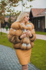 Gorgeous plus size blonde European woman in luxury fur coat, women's beauty. Concept of furs