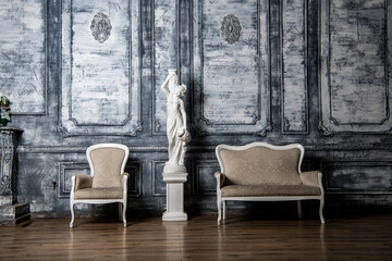 dance hall interior with a statue and sofas on a background of gray walls