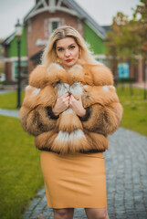 Gorgeous plus size blonde European woman in luxury fur coat, women's beauty. Concept of furs