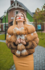 Gorgeous plus size blonde European woman in luxury fur coat, women's beauty. Concept of furs