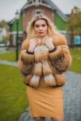 Gorgeous plus size blonde European woman in luxury fur coat, women's beauty. Concept of furs