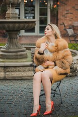 Gorgeous plus size blonde European woman in luxury fur coat, women's beauty. Concept of furs