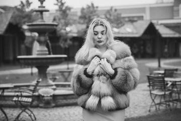 Gorgeous plus size blonde European woman in luxury fur coat, women's beauty. Concept of furs