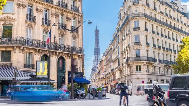 Romantic cozy view of the famous Eiffel tower from a small paris street on a cloudy autumn day with yellow gloden leaves - wide horizontal panorama.Camera zooms out