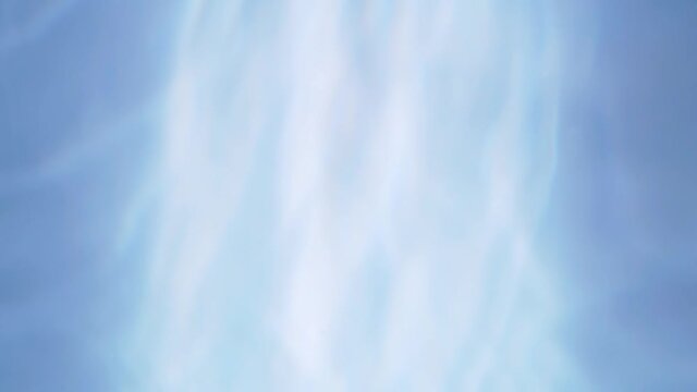 Top view slow motion of drop falling into the water surface and diverging circles on white background