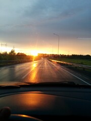car driving on a highway at sunset