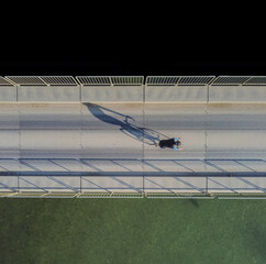 one cyclist on the bridge view from above