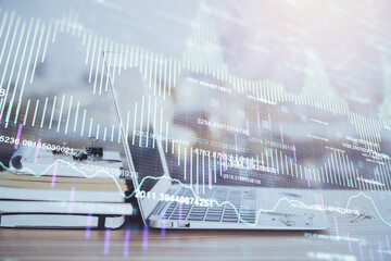 Stock market chart hologram drawn on personal computer background. Double exposure. Concept of investment.