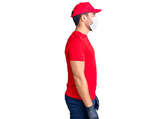 Young hispanic man wearing covid-19 safety mask looking to side, relax profile pose with natural face with confident smile.