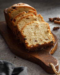 sliced cake on a wooden board with spices
