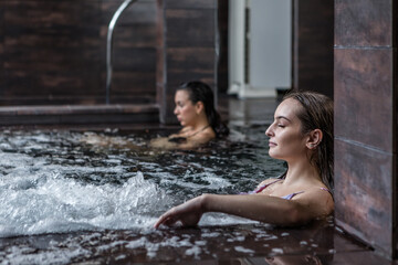 Women relaxing in pool with hydro massage