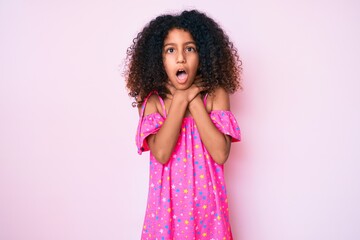 African american child with curly hair wearing casual dress shouting and suffocate because painful...