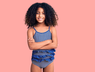 African american child with curly hair wearing swimwear happy face smiling with crossed arms...