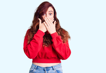 Young beautiful woman wearing casual winter sweater shocked covering mouth with hands for mistake. secret concept.