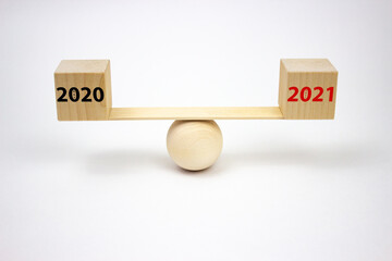 The inscription on the cubes of wooden scales 2020 and 2021 with the words rat and bull, in black and red. The concept of planning the future and analyzing the past.