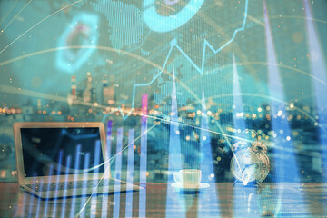 Financial graph colorful drawing and table with computer on background. Multi exposure. Concept of international markets.