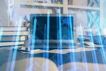 Financial chart drawing and table with computer on background. Multi exposure. Concept of...