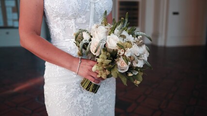 wedding bouquet in hands of bride