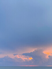 sunrise over storm clouds out at sea