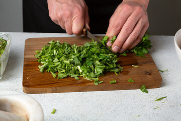 Man chopping fresh greens for food