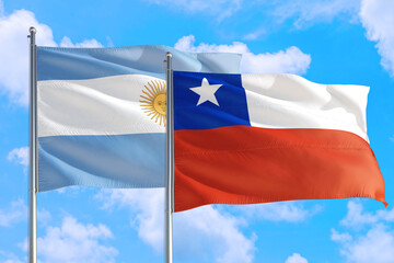 Chile and Argentina national flag waving in the windy deep blue sky. Diplomacy and international relations concept.