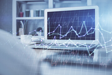 Double exposure of graph and financial info and work space with computer background. Concept of international online trading.