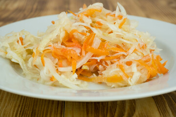 sauerkraut in a plate on a wooden table