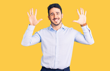 Young hispanic man wearing business clothes showing and pointing up with fingers number ten while smiling confident and happy.